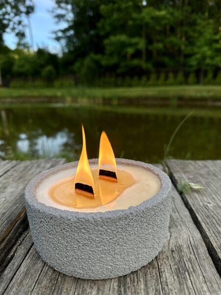 Natural, premium mosquito repellent candle, in a gray ceramic container